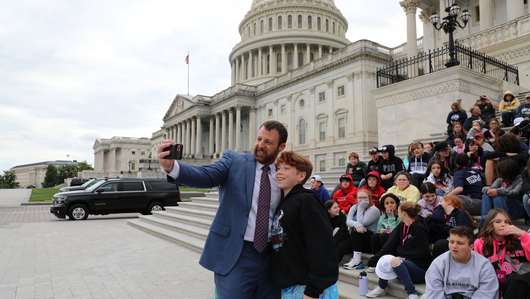 Mullin taking a selfie with a touring student