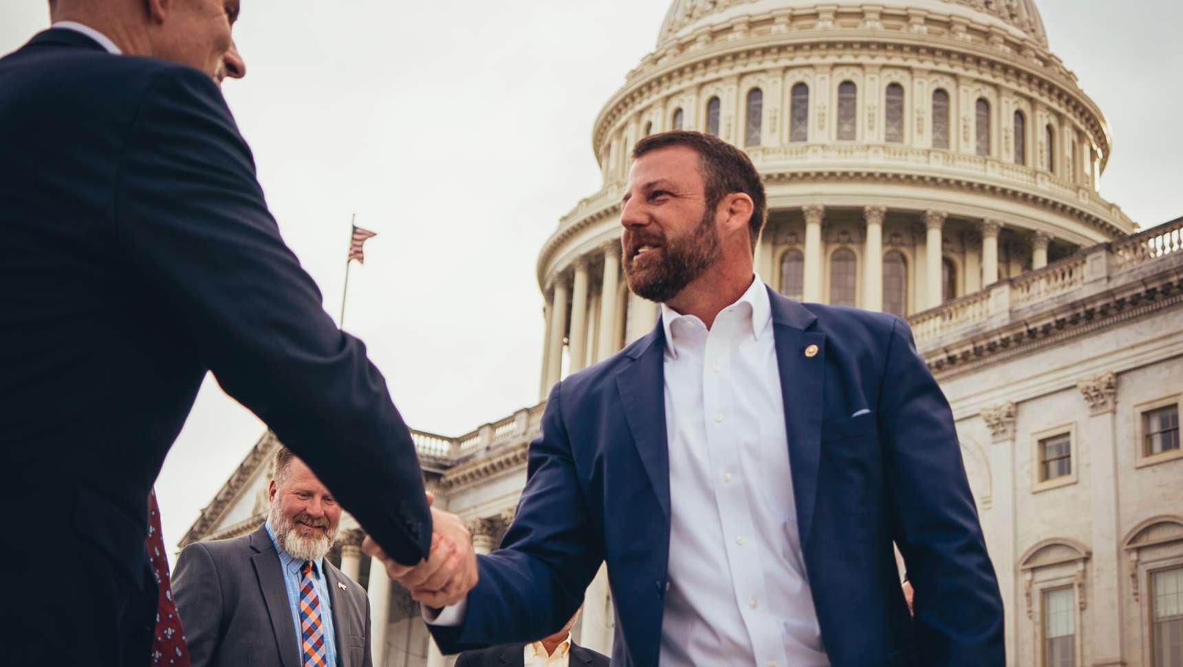 Senator Mullin shaking hands in front of the capitol building